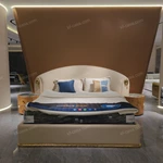 Beige Leather Upholstered Bed with Gold Stainless Steel Elephant Head Accents & Hammered Base Trim